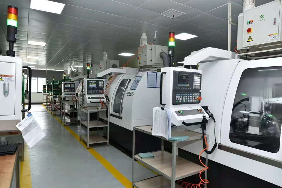 Row of enclosed machining equipment and control panels in a workshop