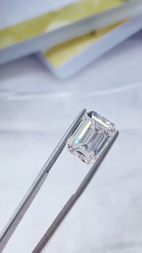 Emerald white diamond held in tweezers, extracted from supplied video