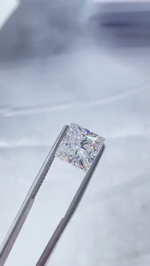 Princess white diamond held in tweezers, extracted from supplied video