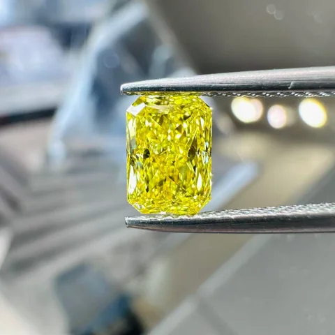 Yellow radiant diamond held in tweezers, supplied photograph